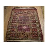 A Turkoman rug, decorated geometric motifs on a red ground,