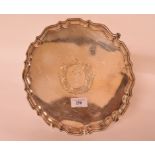 A silver salver, with pie crust edge, crested within a cartouche, Sheffield 1927, approx. 19.