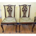 A pair of George III walnut dining chairs, with pierced vase shaped splats,