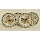 A set of four 19th century Dutch polychrome Delft plates, decorated flowers and foliage,