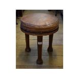 An Art Deco walnut stool, with leather upholstered top on three tapering legs, 34.