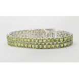 A silver and peridot double line bracelet