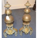 A pair of brass fire dogs,