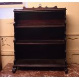 A waterfall front open bookcase, on scroll toes,