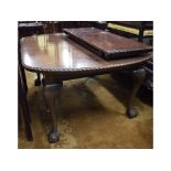 A mahogany extending dining table, inset two extra leaves, on cabriole legs with claw and ball feet,