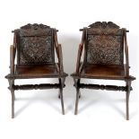 A pair of Glastonbury style oak armchairs,