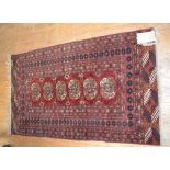 An Eastern rug, decorated two lozenges on a pink ground, within a multi border, 147 x 97 cm,