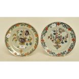 A matched pair of 19th century Dutch polychrome Delft plates, decorated flowers and foliage,