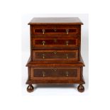 An early 18th century style miniature chest on chest, veneered in walnut and oyster cut sections,