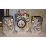 A 19th century pottery clock garniture, decorated flowers, the clock 29.