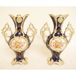 A pair of porcelain two handled vases, decorated flowers,