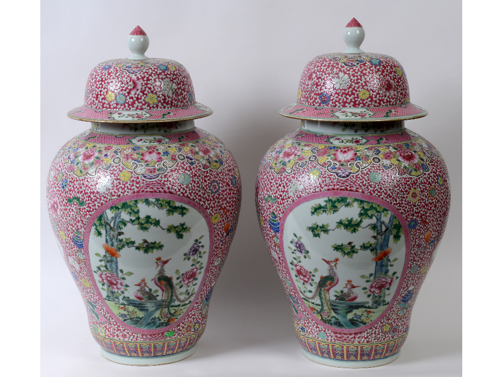 Two large Chinese porcelain famille rose vases and covers, decorated birds, flowers, and foliage,