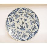 A Delft plate, decorated chickens, flowers and foliage, chipped and cracked, 34 cm diameter,