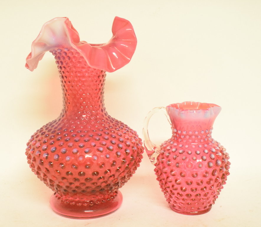 A cranberry and opalescent glass vase, with fluted rim, 26 cm high, and a similar jug,