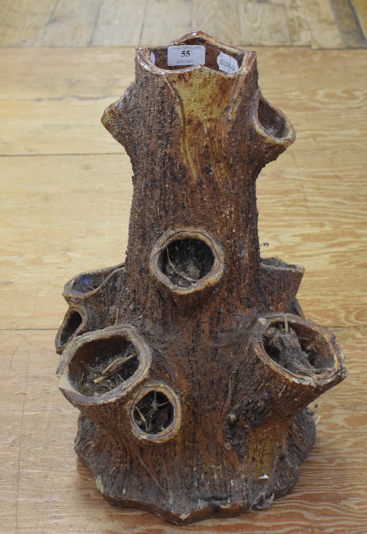 A pottery planter, in the form of a tree stump,