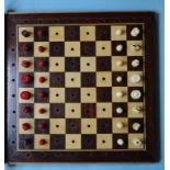 An early 20th century inlaid mahogany travelling chess set,