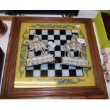 A glazed and framed painted chess board,