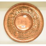 An Arts and Crafts embossed copper circu