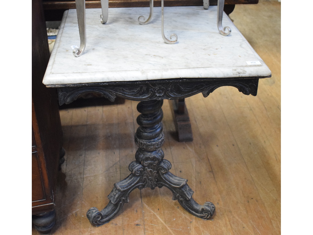 An ebonised marble top tripod occasional