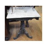 An ebonised marble top tripod occasional