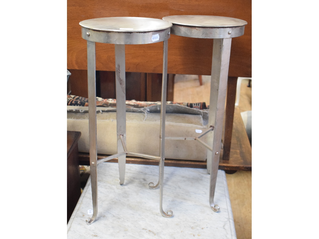 A pair of wrought iron circular stools,