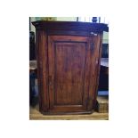 A 19th century stained pine corner cupbo