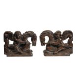 A PAIR OF CARVED OAK PUTTI MOUNTED ON SEAHORSES