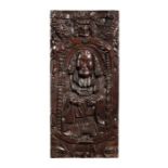 AN ELIZABETHAN CARVED OAK PANEL OF A ROBED CLERIC