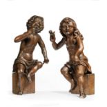 A PAIR OF CARVED OAK PUTTI