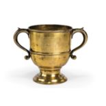 A GEORGE II BRASS TWIN-HANDLED CUP