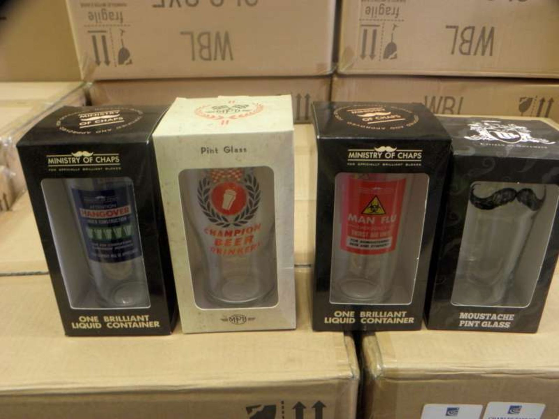 144 X VARIOUS NOVELTY PINT GLASSES IN 12 SMALL BOXES
