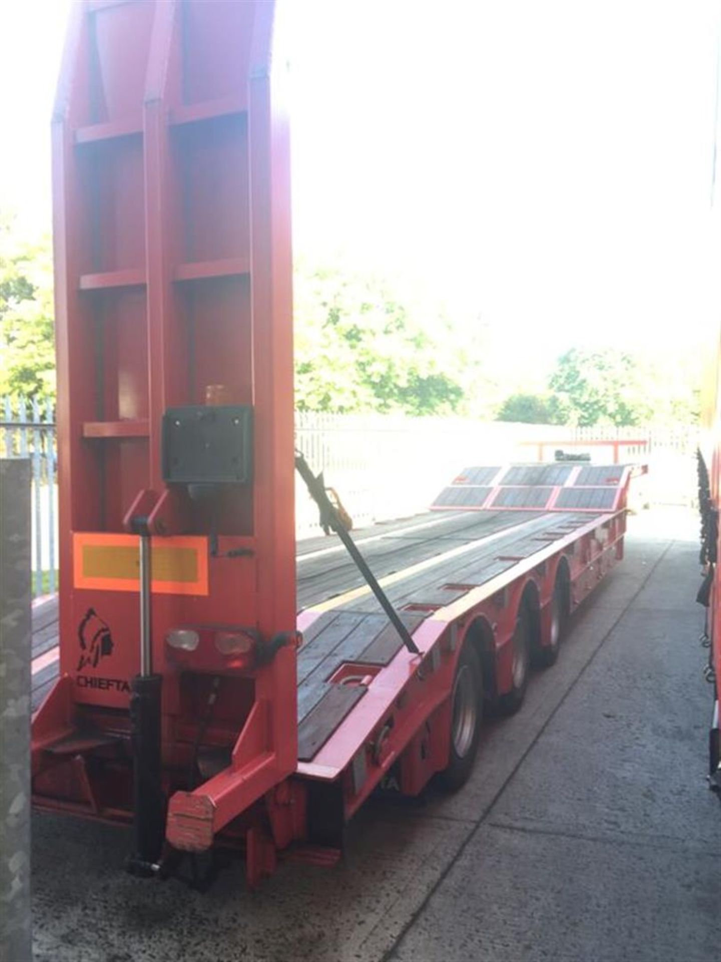 2009 Chieftain tri-axle step frame low loader trailer with hydraulic ramps and wooden floor