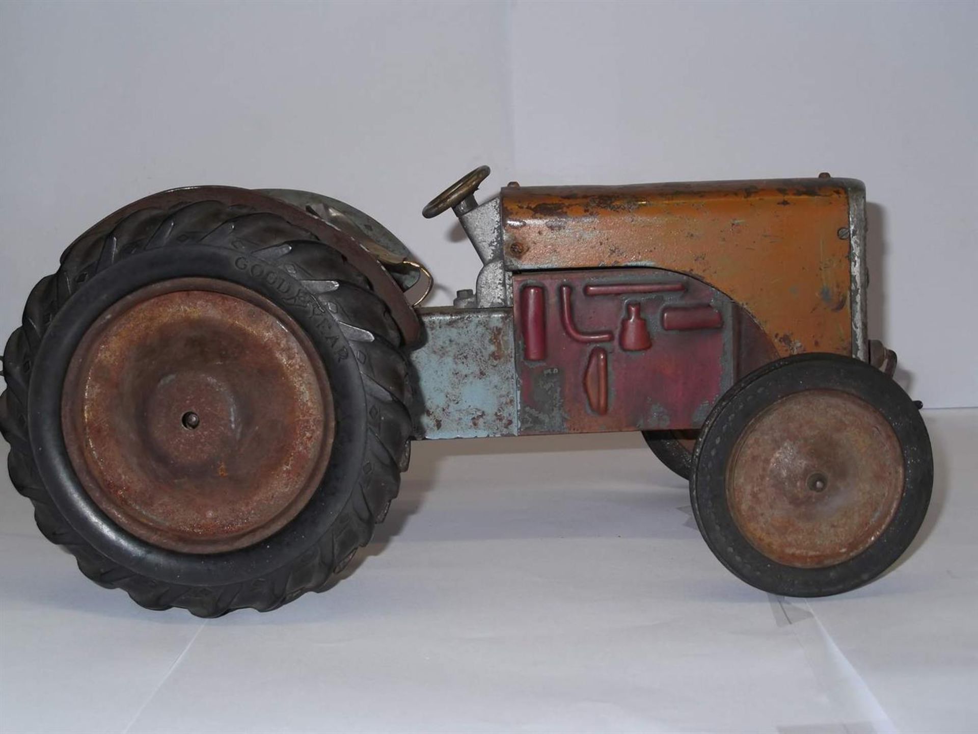 Ferguson salesmans clockwork tractor in worn condition with evidence of earlier overpainting