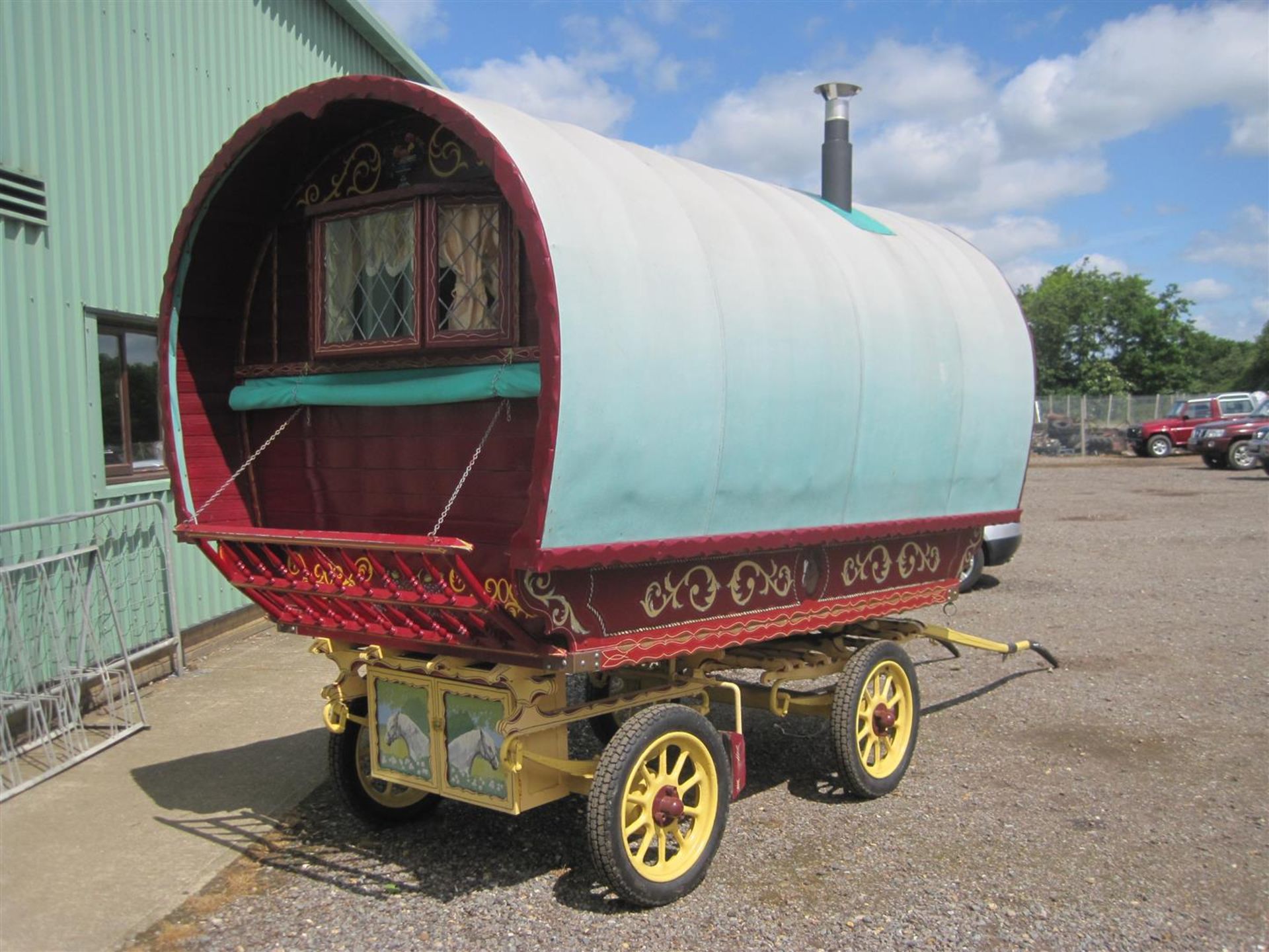 Bowtop horsedrawn caravan, the well carved and decorated wagon of modern origin has a leaded pane