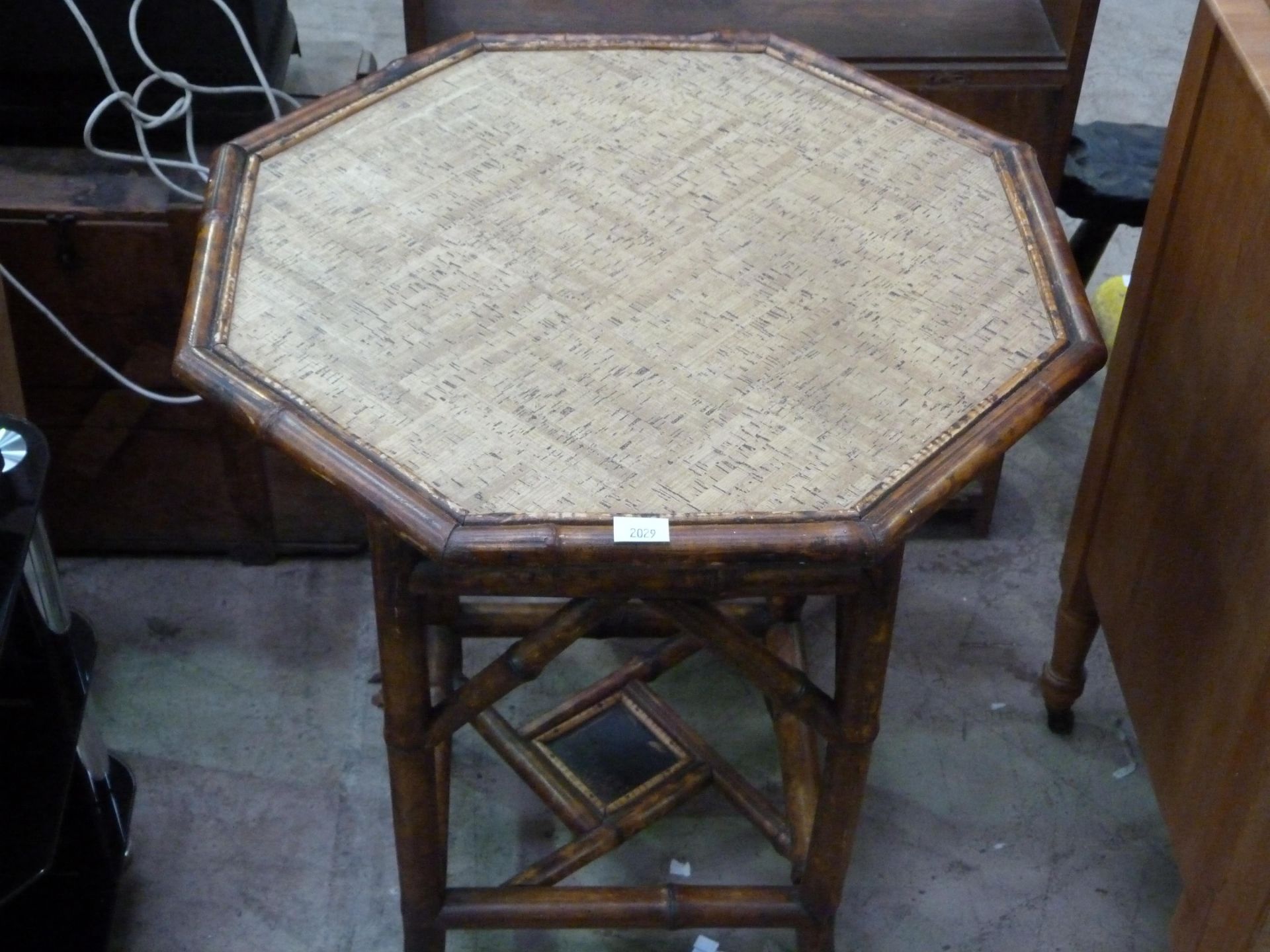 A bamboo octagonal table (H73cm, W58.5, D58.5cm) (est £20-£40)