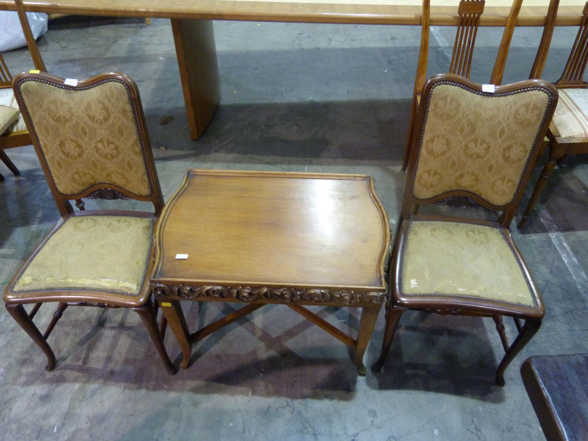 Two upholstered carved chairs together with a carved coffee table (H47cm, L67cm, W48cm) (3) (est £