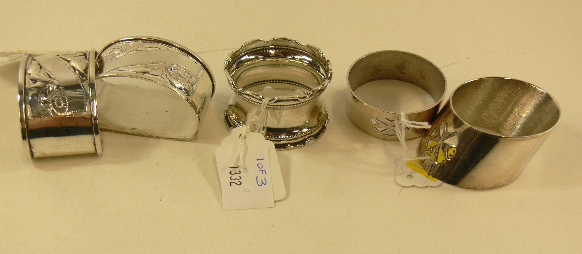 A hallmarked silver napkin ring (approx 15g) together with two further napkin rings stamped '800' (