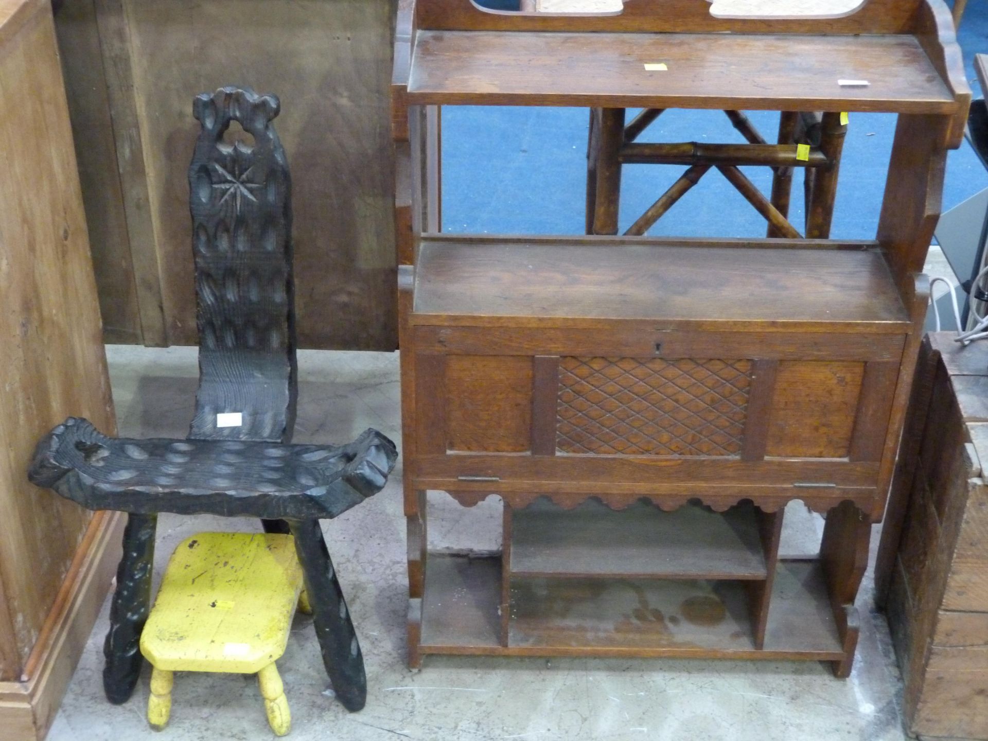 A carved hanging shelf unit (H87cm, L61cm, W19cm), and unusual carved stool (H75cm) & a small yellow