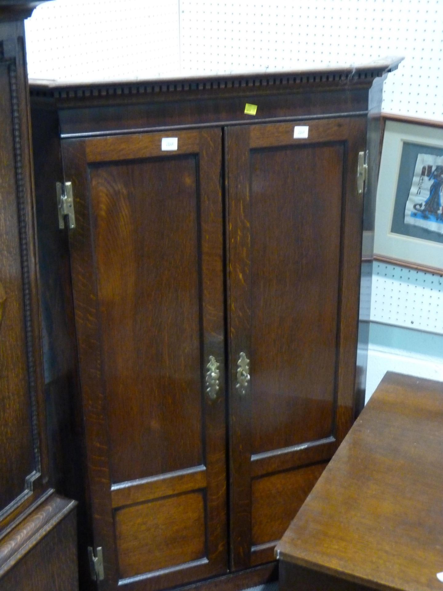 A brass handled dark wood corner cabinet (H121cm, L87cm, W50cm) (est £50-£80)