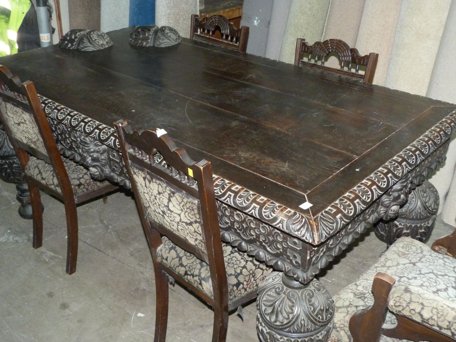 A large & heavily carved Jacobean style dining table. The table has had a woodworm infestation to