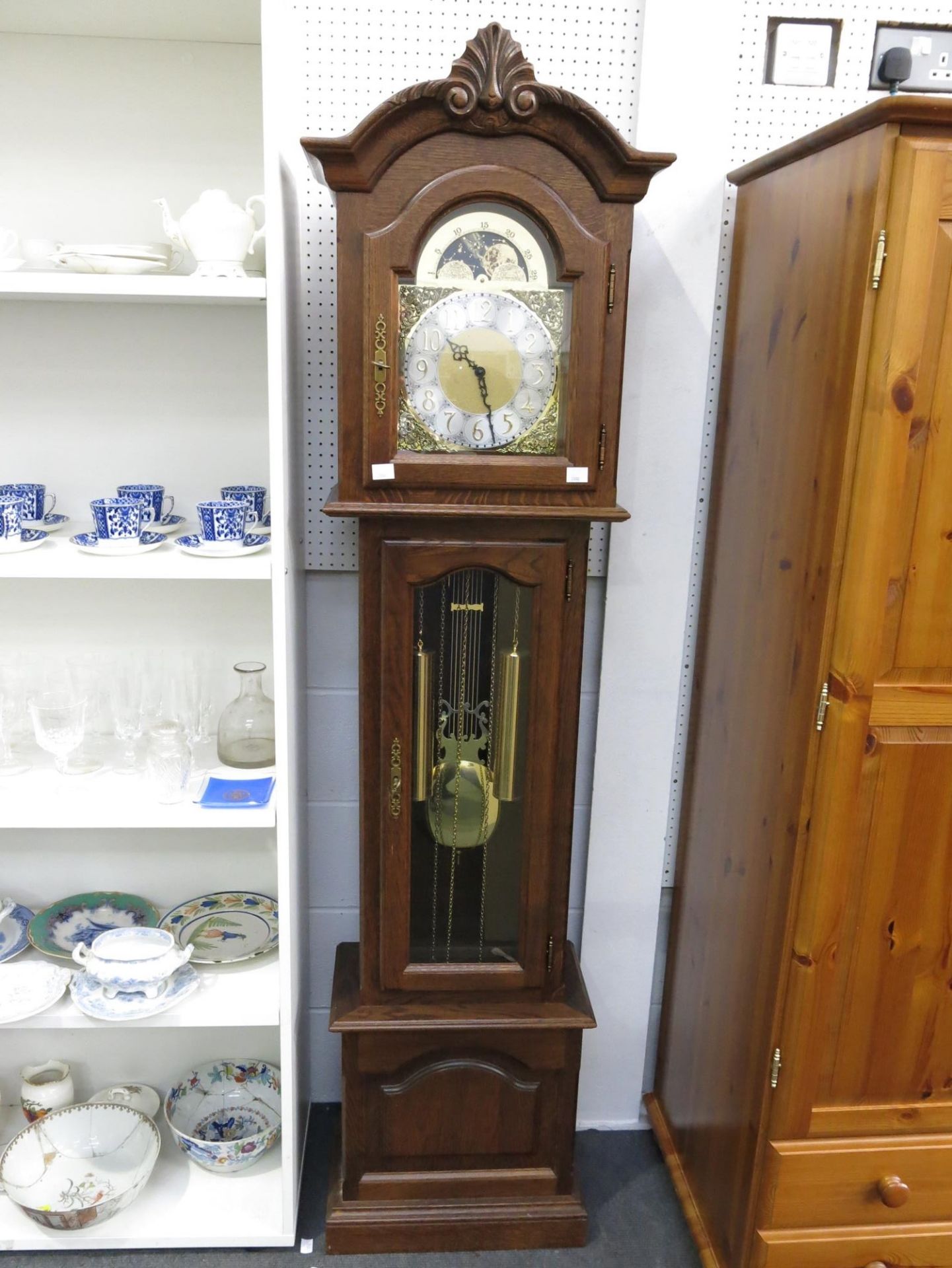 An oak framed longcase clock featuring various chimes (H193cm, W50cm, D26cm) (est £60-£100)