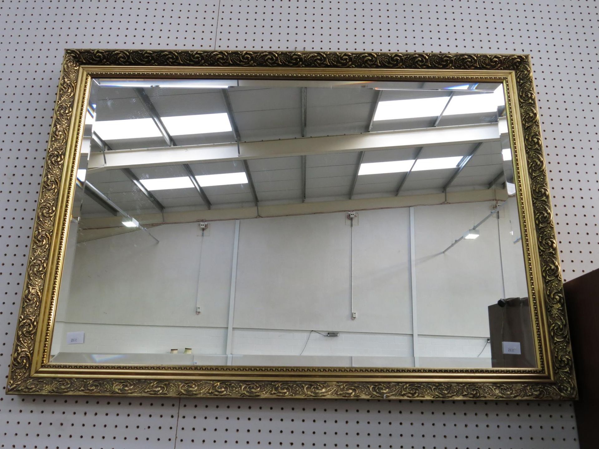 A gold coloured frame with bevelled mirror (H71cm, W99cm) (est £30-£40)