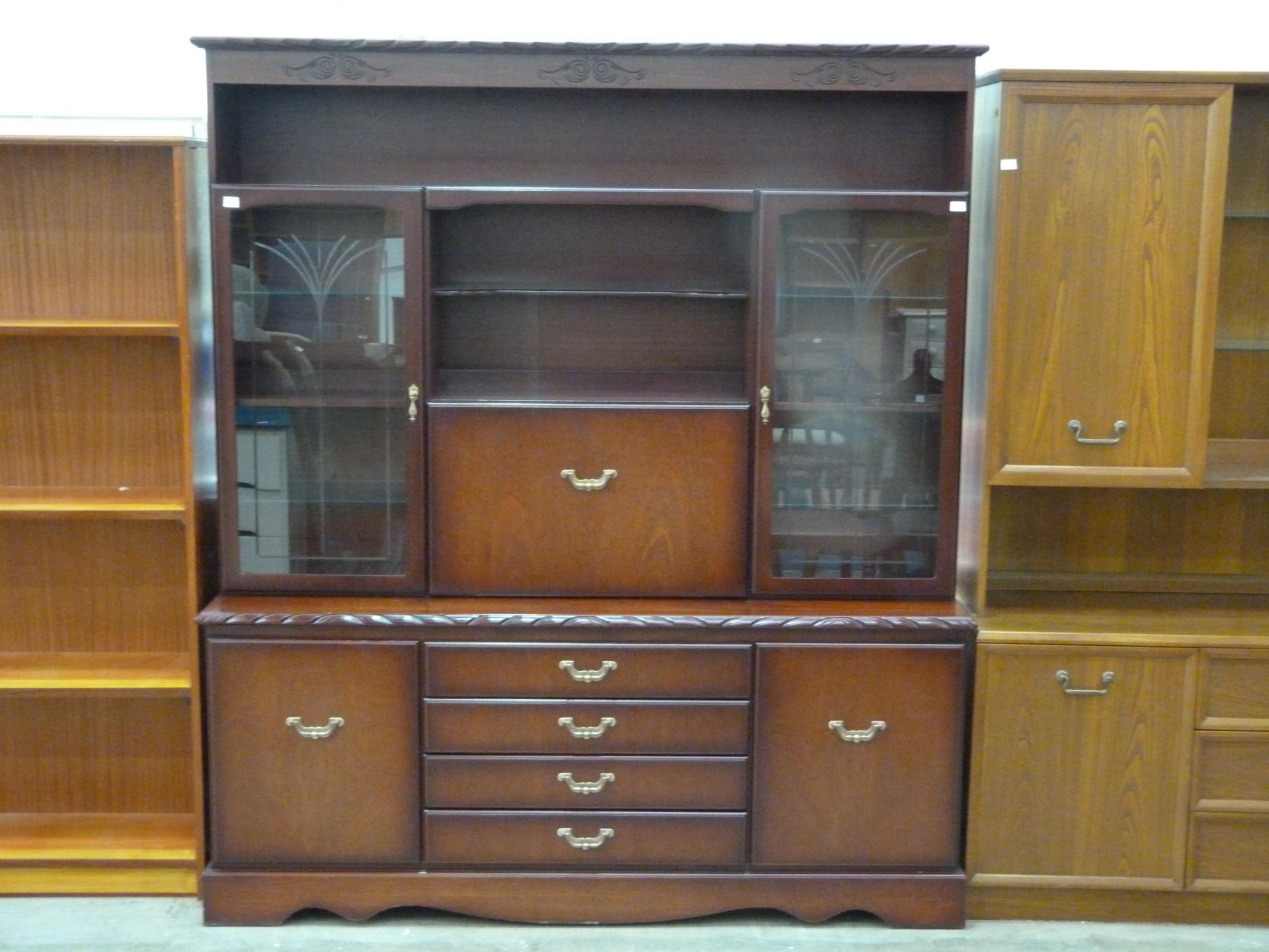 A large John Coyle illuminated buffet unit featuring brass drop handles, five doors (two with etched