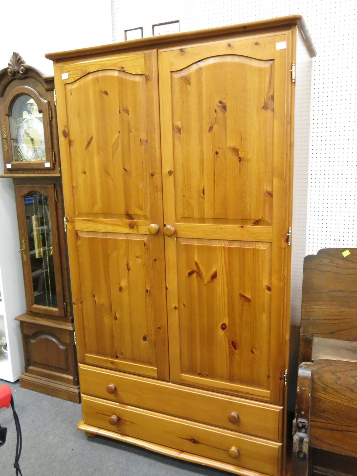 A pine double door wardrobe with two full size drawers below. (Height- 181cm, Width- 104cm,