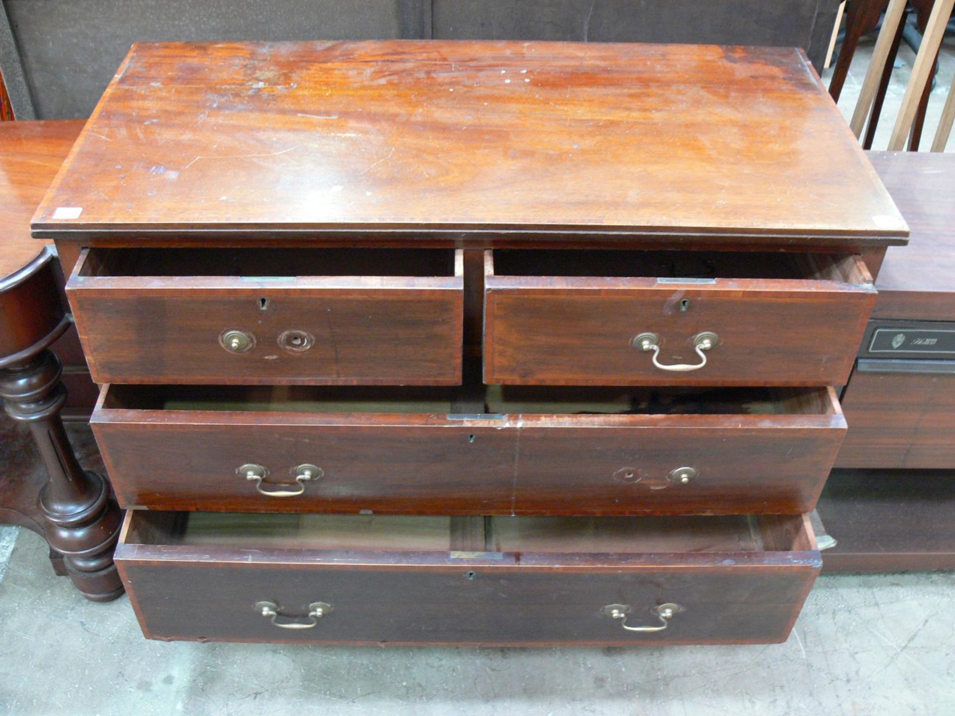 A mahogany chest of four drawers with metal drop handles (H82cm W108cm D51cm) (est £70-£90) - Image 2 of 2