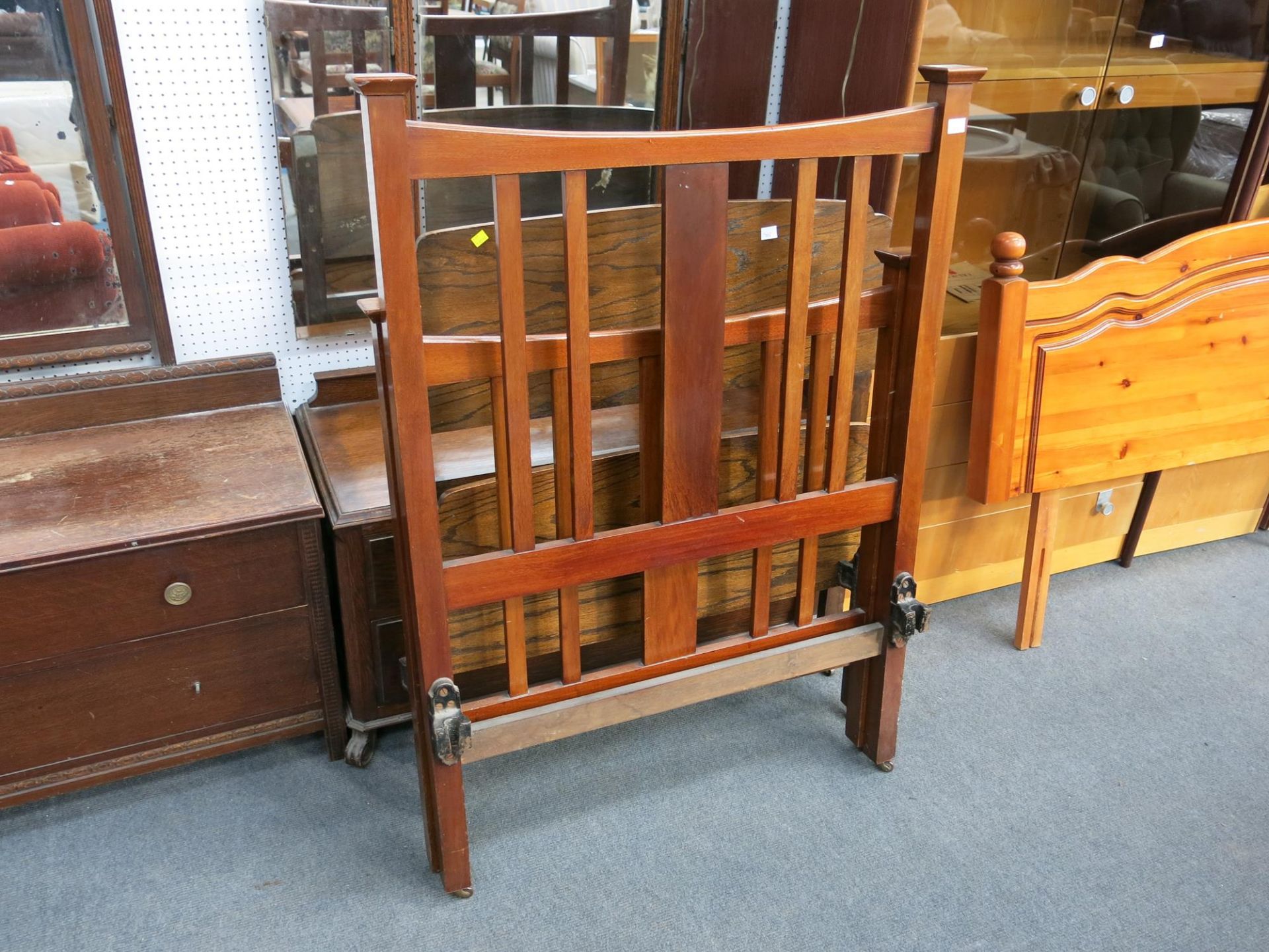 A single head and foot board together with a tilting mirror back chest of two drawers and a three
