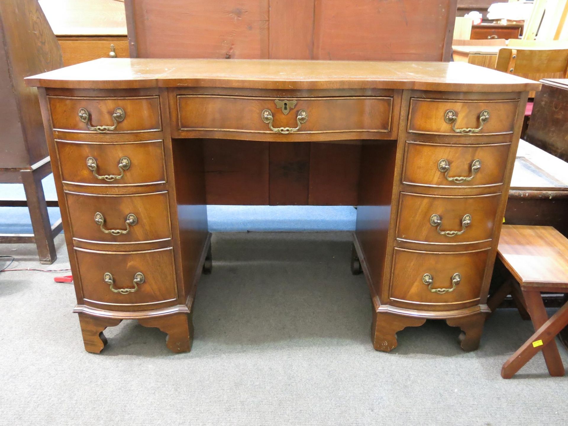 A pedestal desk with nine drawers and leather inlaid writing surface (H 76cm, W 115cm, D 52cm) ( - Image 2 of 3