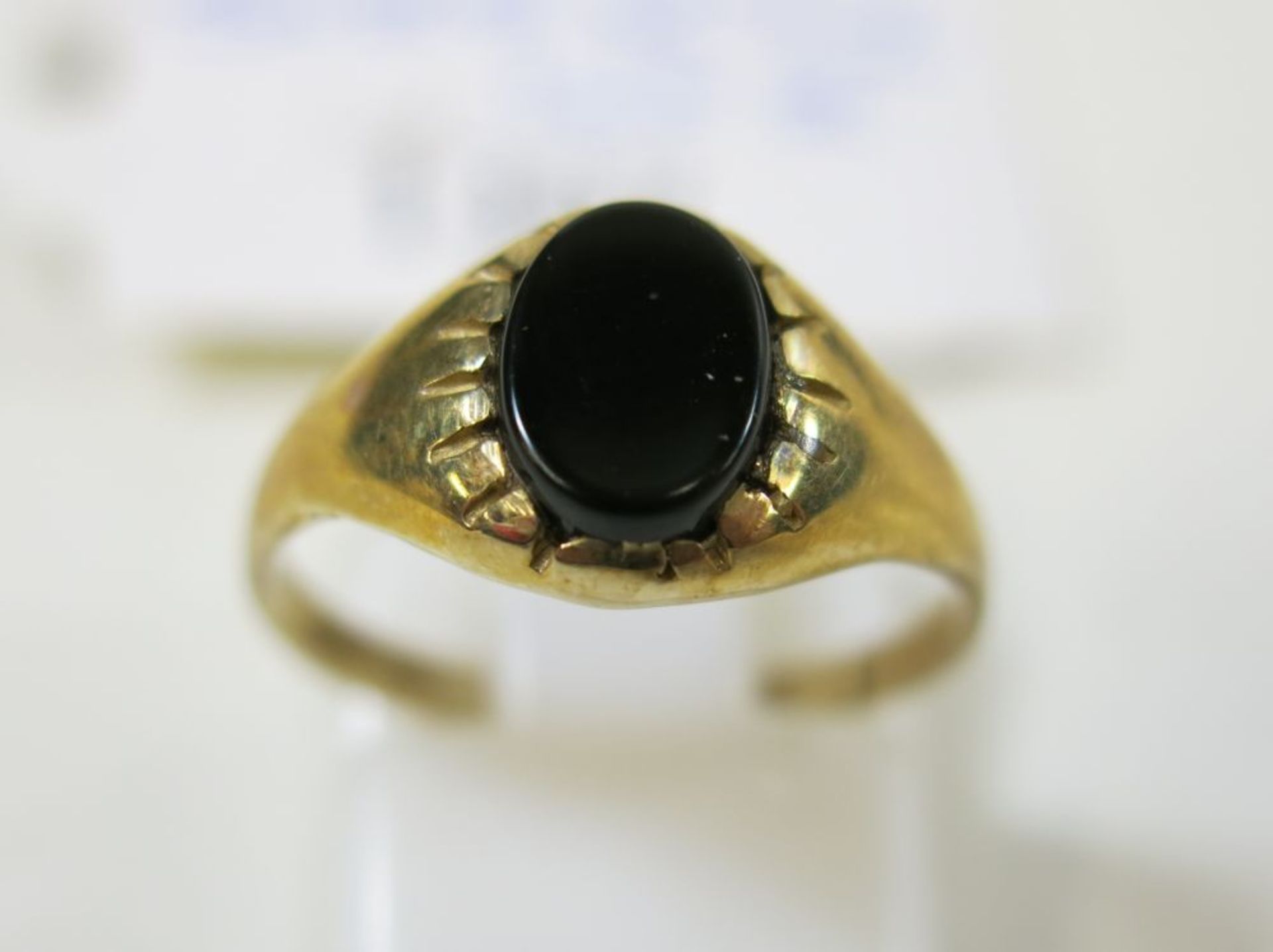 A 9ct gold black onyx set oval signet ring (size K½) together with a pair of gold sleeper earrings