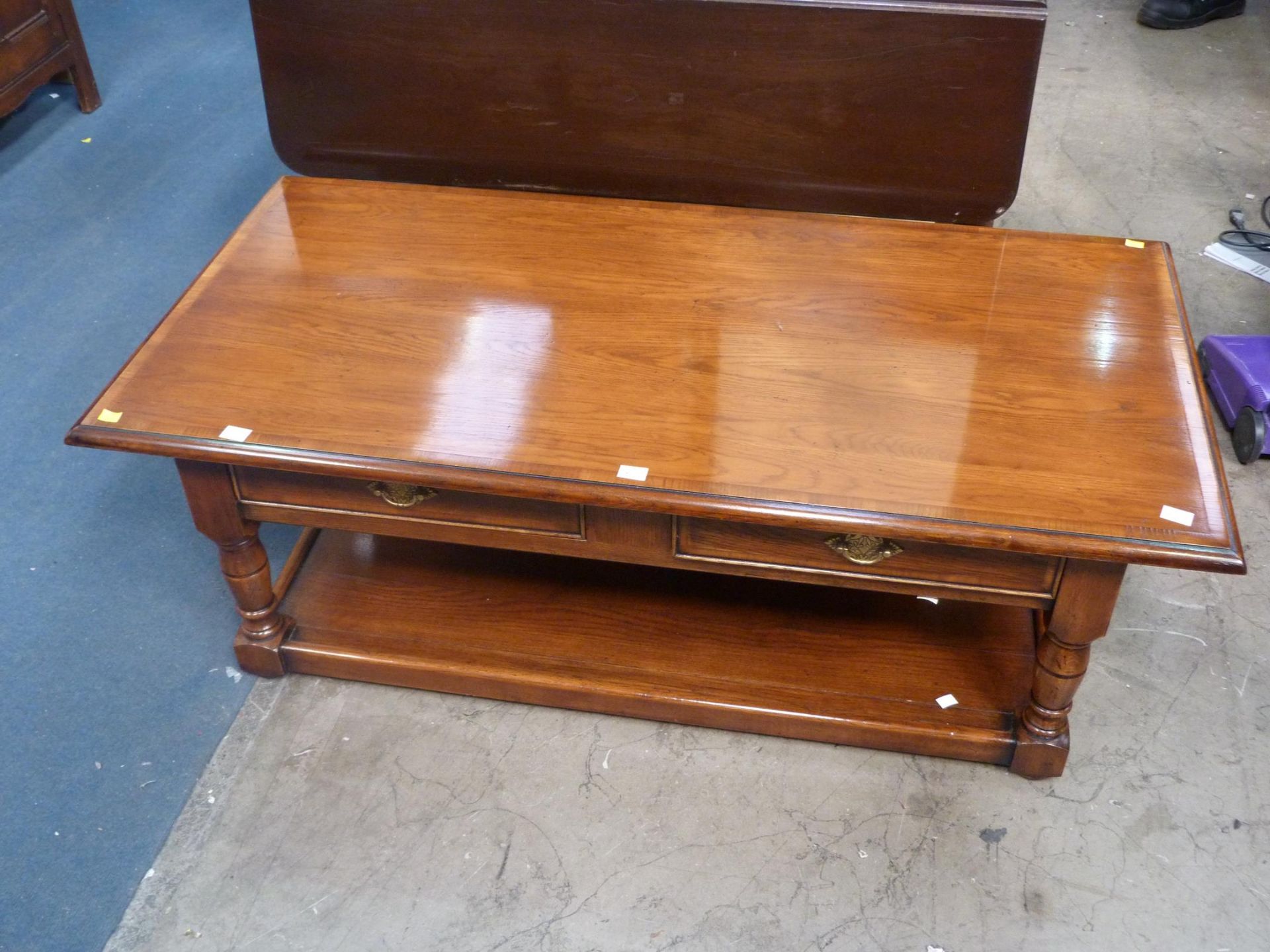 A Walnut Coffee Table with two drawers with metal drop handles, with undertier (H 46cm, W 129cm, D