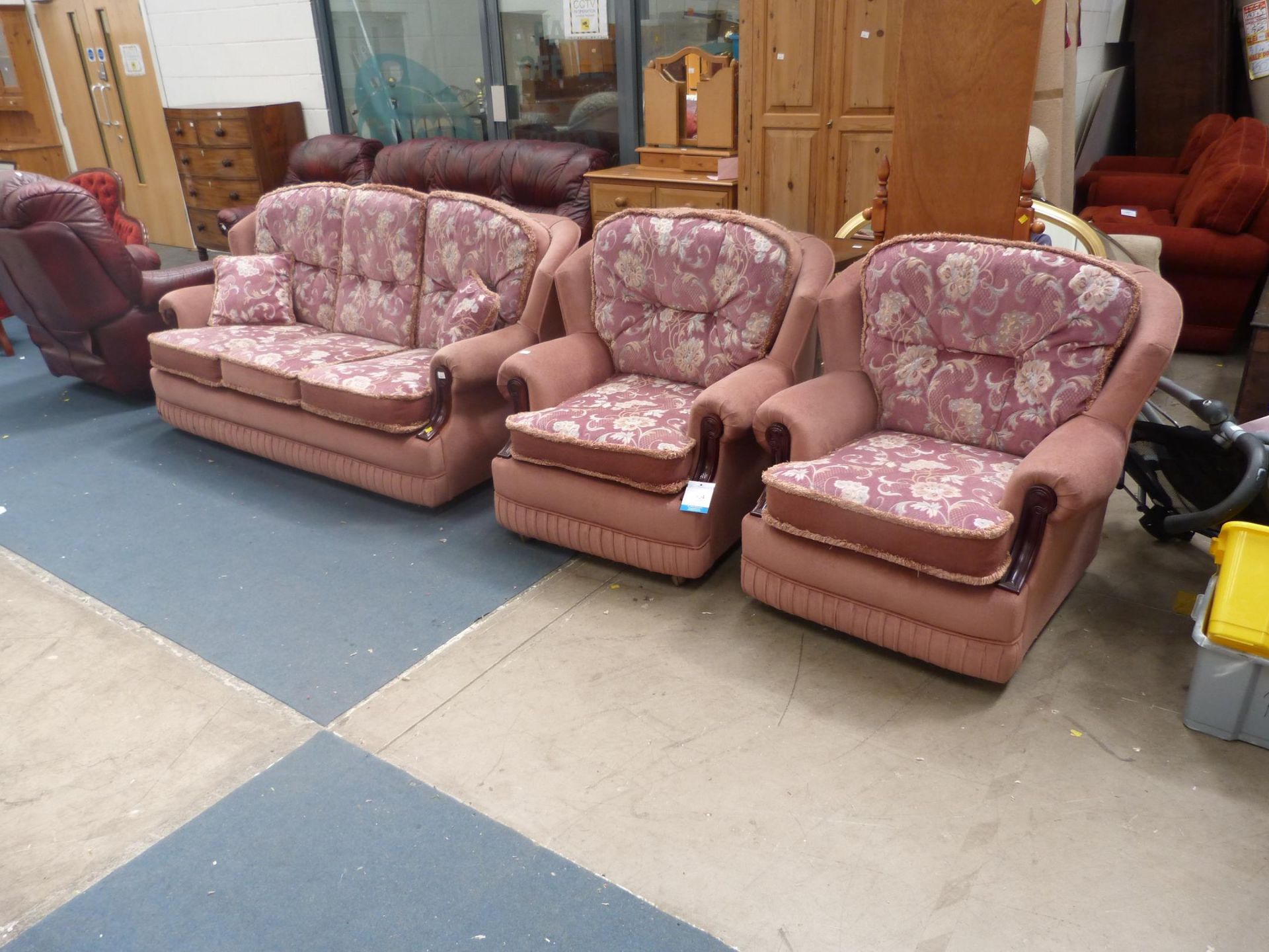 A Pink and Floral Pattern Velure Three Piece Lounge Suite (est £50-£80)